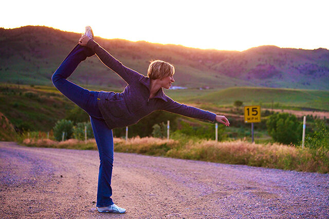 Eine Frau macht Yoga im Morgengrauen
